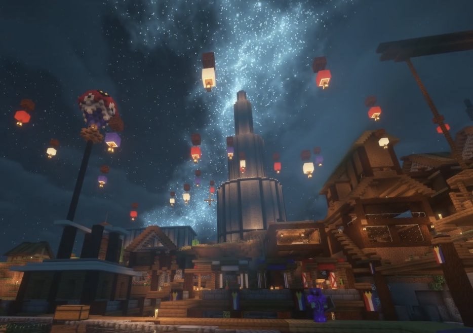 This is a screenshot from Phil's stream. He has shaders on, making the night sky in minecraft a starry, galaxy-filled one. The picture contains a few buildings like Tubbo's old house and the strip of houses outside the main marketplace square. A player stands in full netherite armor next to one of the posts, but it is unclear as to who the player is.